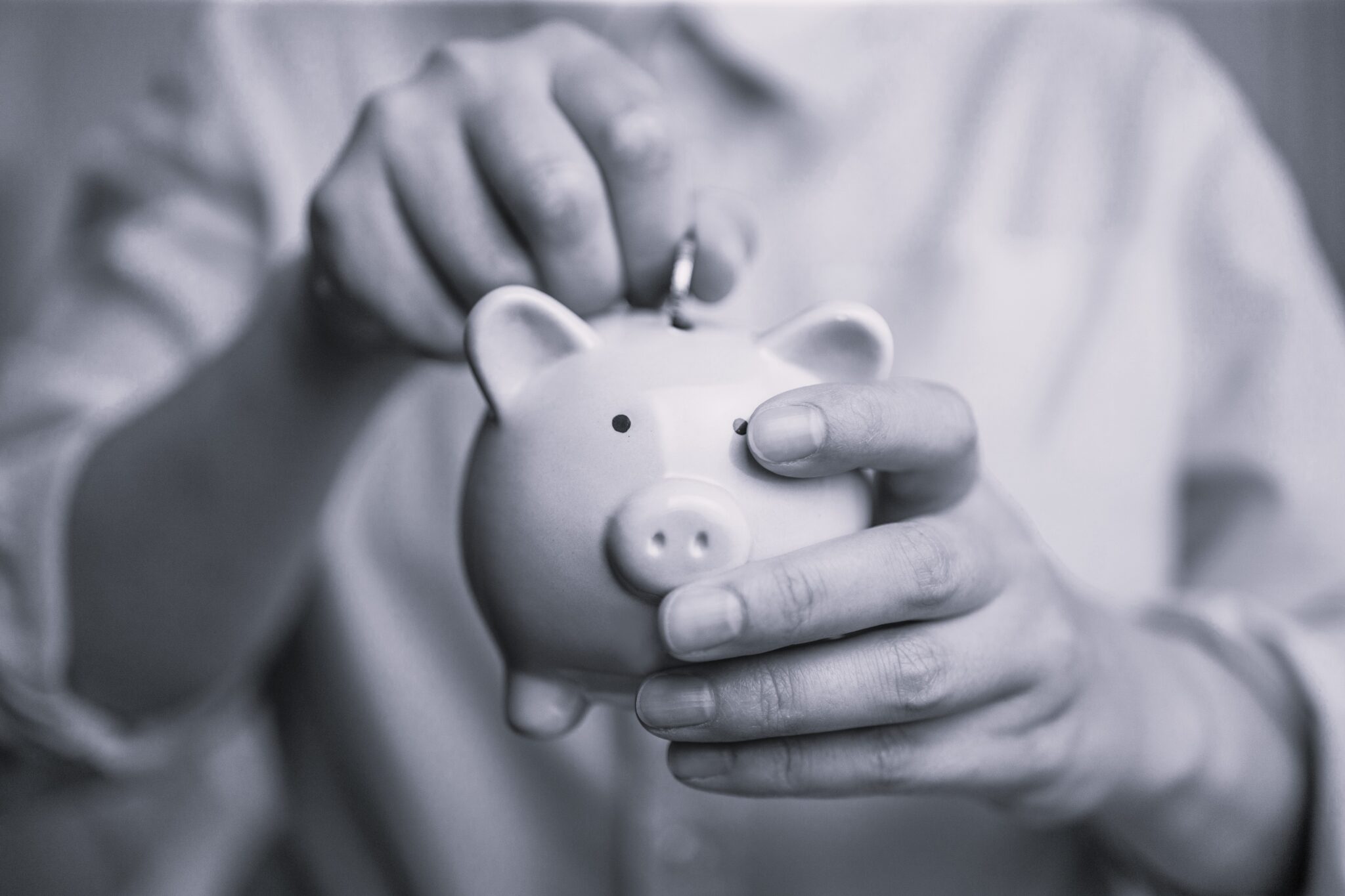 Woman hands hold a pink piggy bank and coin puts. Saving money or savings, investment concept