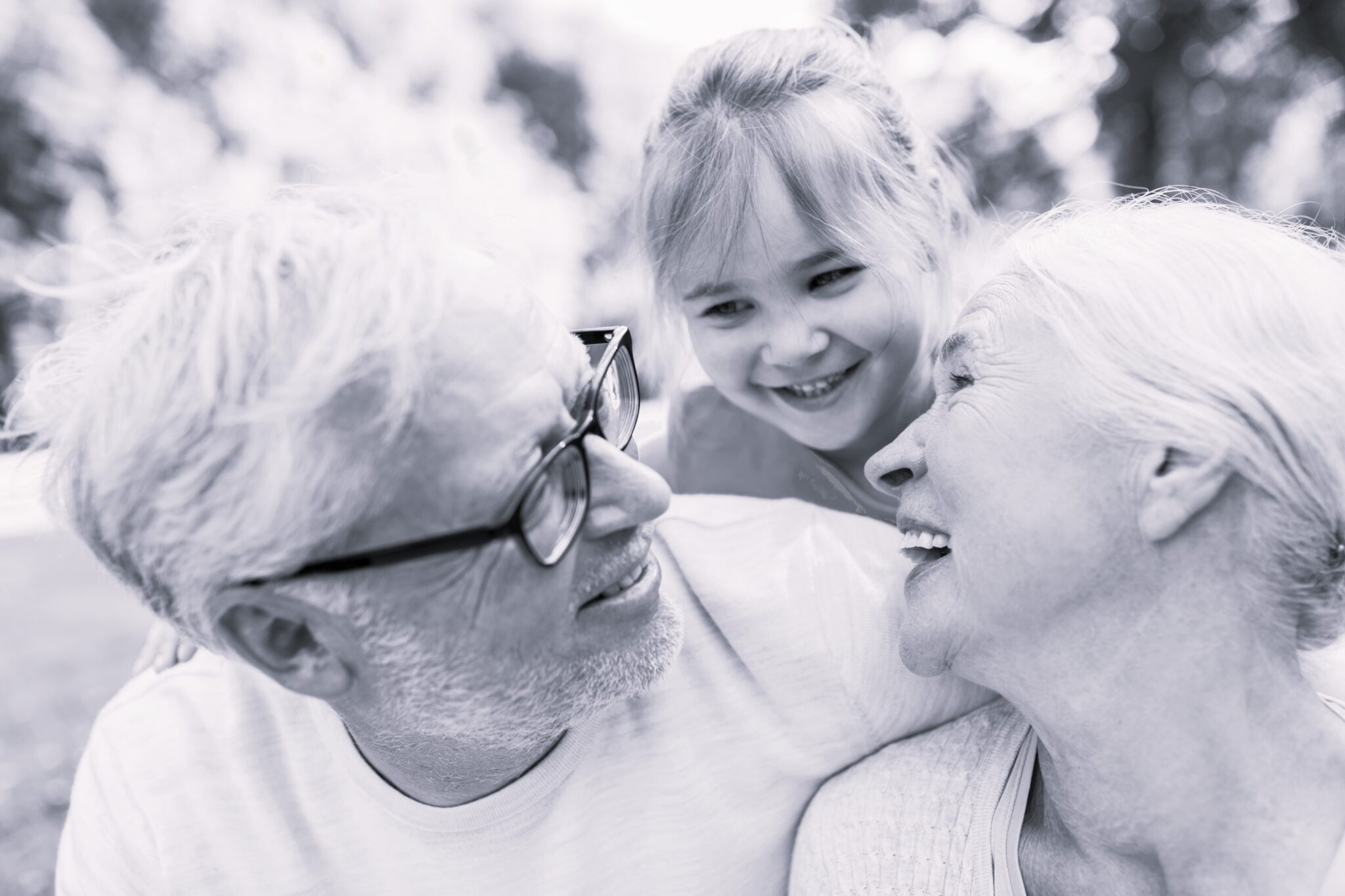 family, generation and people concept - happy smiling grandmother, grandfather and little granddaughter at park